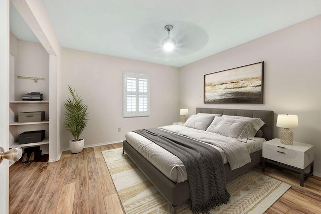 bedroom with light wood-type flooring and ceiling fan