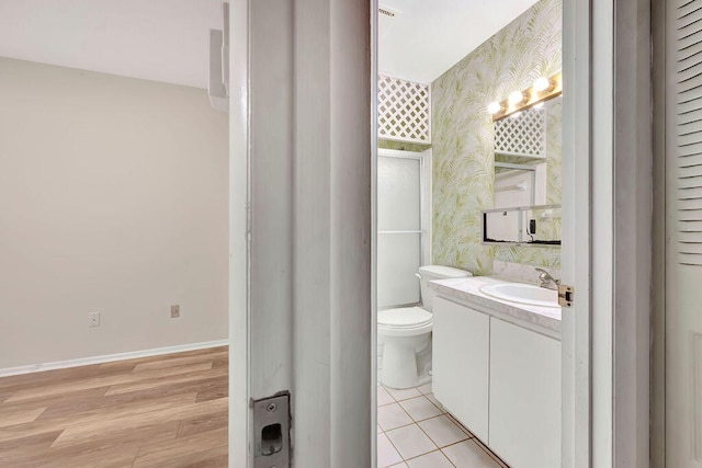 bathroom with vanity, hardwood / wood-style flooring, and toilet