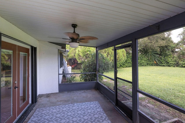 unfurnished sunroom featuring ceiling fan