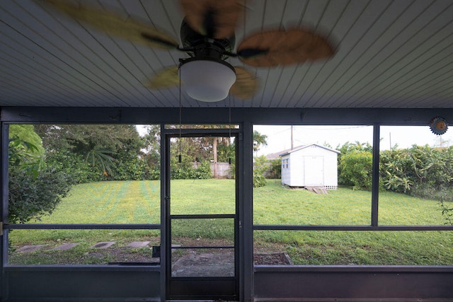 unfurnished sunroom with ceiling fan