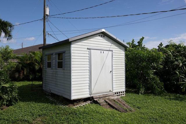 view of outbuilding featuring a yard