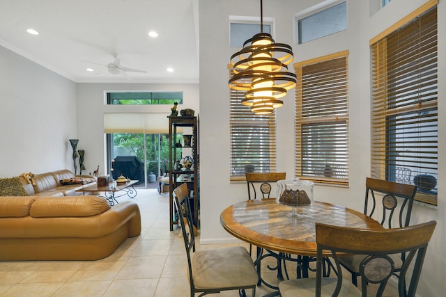 dining area with ceiling fan with notable chandelier, light tile patterned floors, and ornamental molding