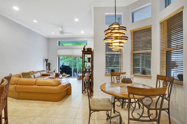 dining space featuring ceiling fan with notable chandelier, ornamental molding, and light tile patterned flooring