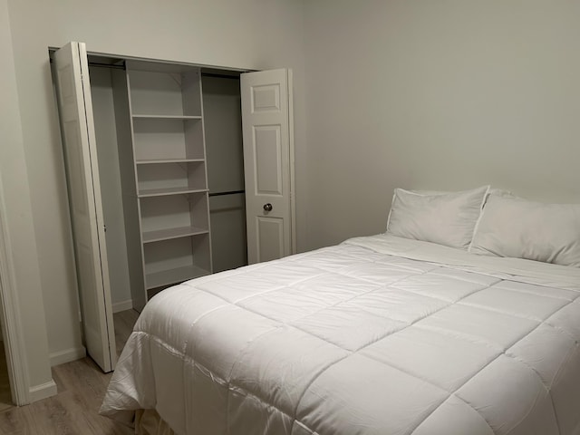 bedroom with a closet and hardwood / wood-style flooring