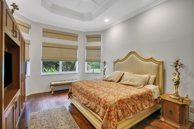 bedroom with a raised ceiling, crown molding, ceiling fan, and dark wood-type flooring