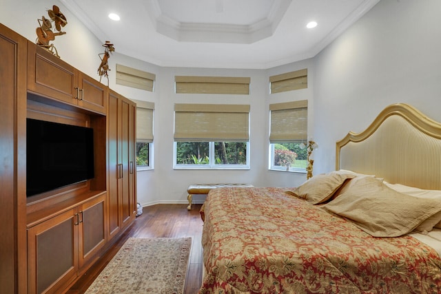 bedroom featuring a tray ceiling, crown molding, and dark hardwood / wood-style floors