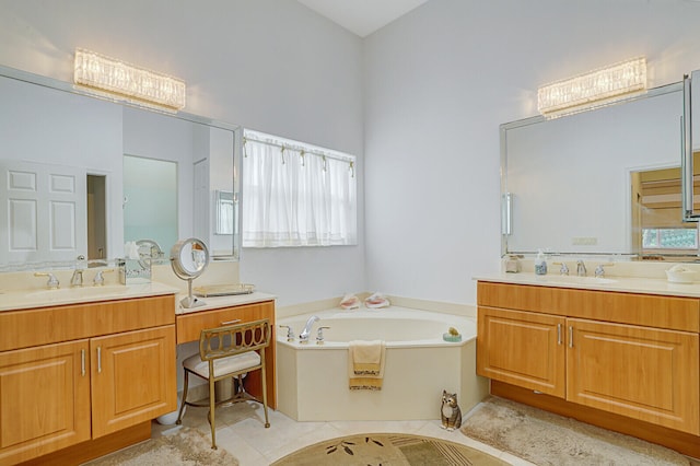 bathroom with tile patterned flooring, plenty of natural light, a bathtub, and vanity