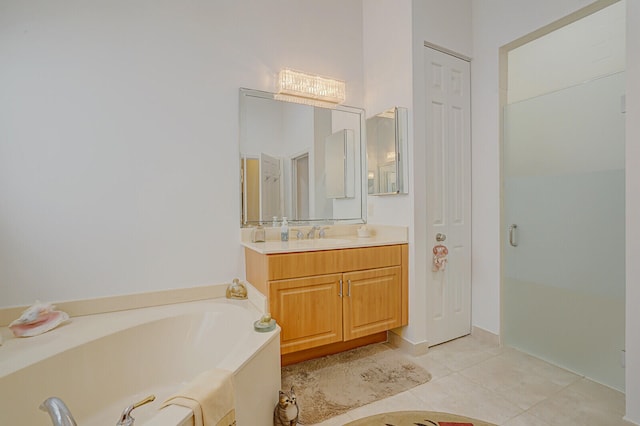 bathroom featuring tile patterned floors, vanity, and a bathing tub