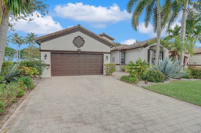 mediterranean / spanish-style home featuring a garage