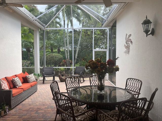 sunroom featuring ceiling fan and a healthy amount of sunlight