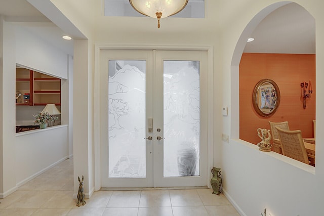 doorway featuring light tile patterned floors and french doors