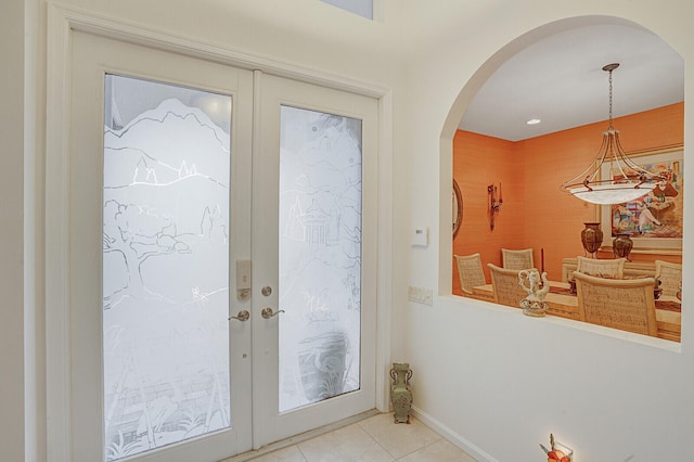 tiled entrance foyer featuring french doors