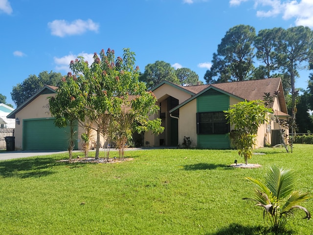 view of front of house featuring a garage and a front lawn