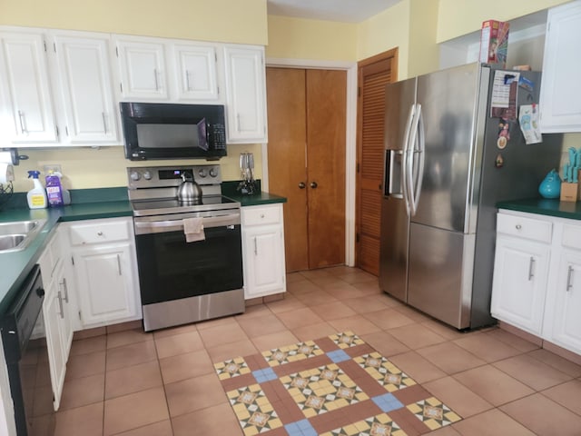 kitchen with white cabinets, sink, light tile patterned floors, and black appliances