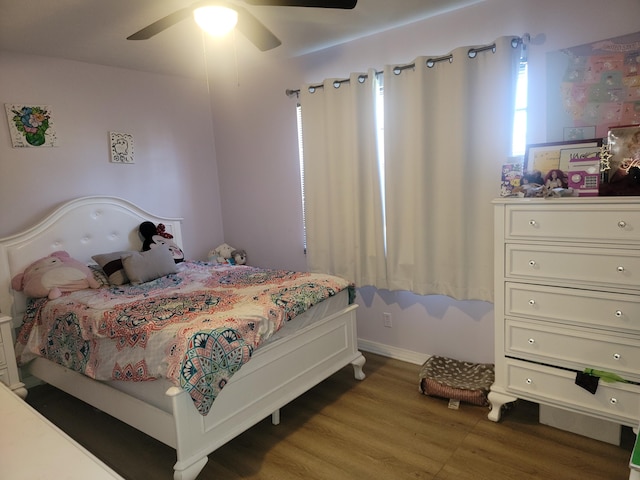 bedroom with ceiling fan and hardwood / wood-style flooring