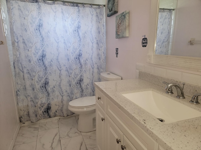 bathroom featuring walk in shower, vanity, and toilet