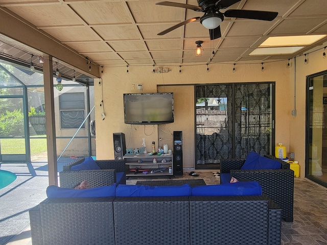 view of patio featuring a lanai, ceiling fan, and an outdoor hangout area