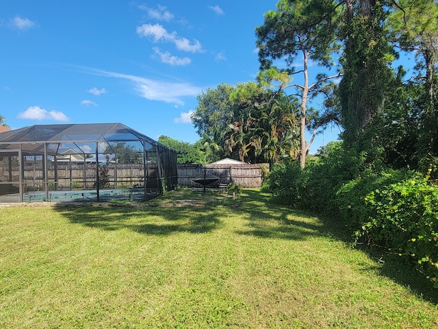 view of yard with glass enclosure