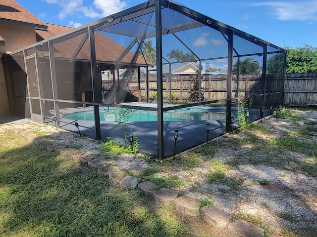 view of pool with glass enclosure