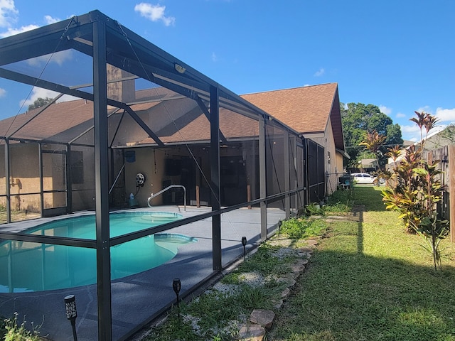 view of pool featuring a lawn, a lanai, and a patio area