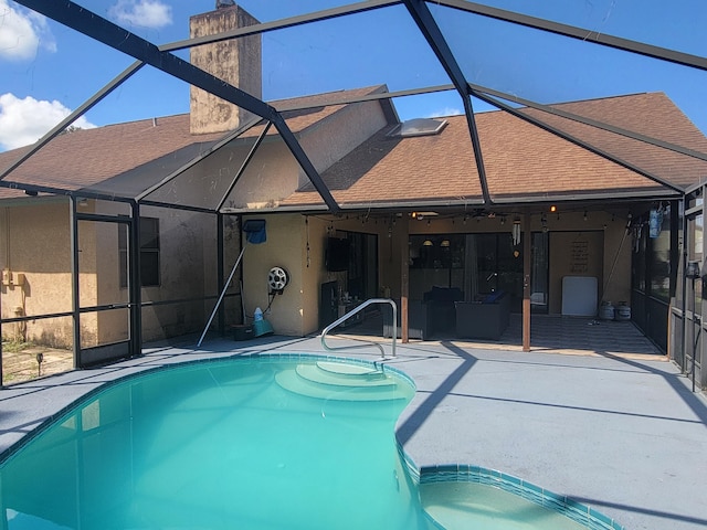 view of swimming pool featuring a patio and glass enclosure