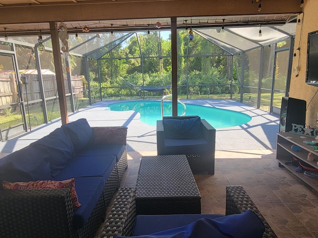 view of pool with outdoor lounge area, a lanai, and a patio area