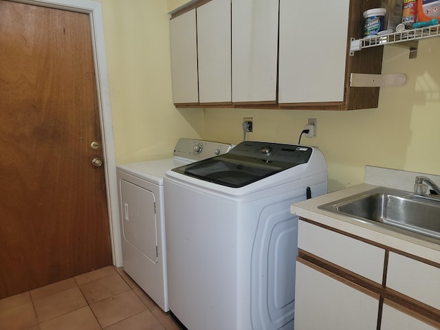 laundry room featuring separate washer and dryer, cabinets, sink, and light tile patterned flooring