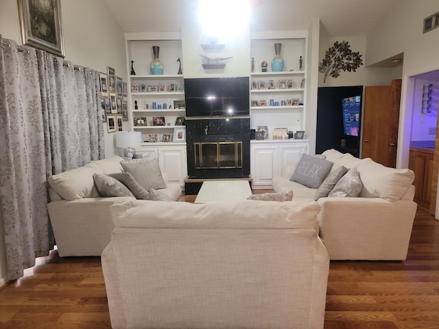 living room with a fireplace and dark wood-type flooring