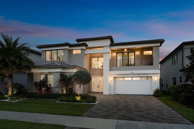 view of front facade with a yard and a garage