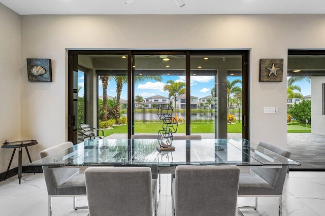 dining space with a wealth of natural light and a water view