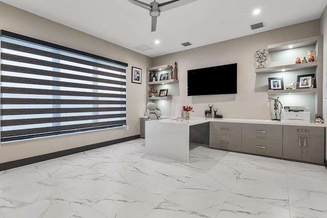 office area featuring ceiling fan and built in shelves