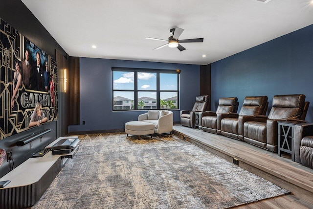 home theater with hardwood / wood-style floors and ceiling fan