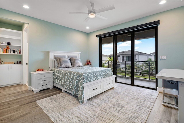 bedroom with access to exterior, light hardwood / wood-style floors, and ceiling fan