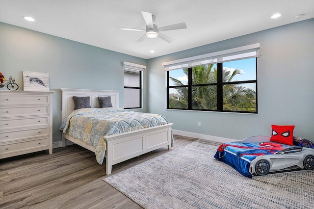 bedroom with ceiling fan and wood-type flooring