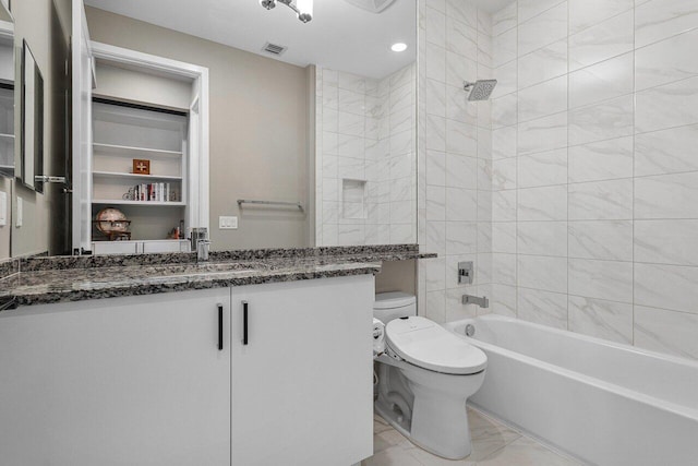 full bathroom featuring vanity, tiled shower / bath combo, and toilet