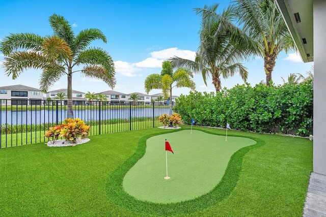 view of property's community with a lawn and a water view