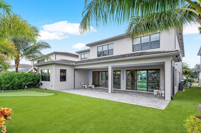 rear view of property with a patio area and a lawn