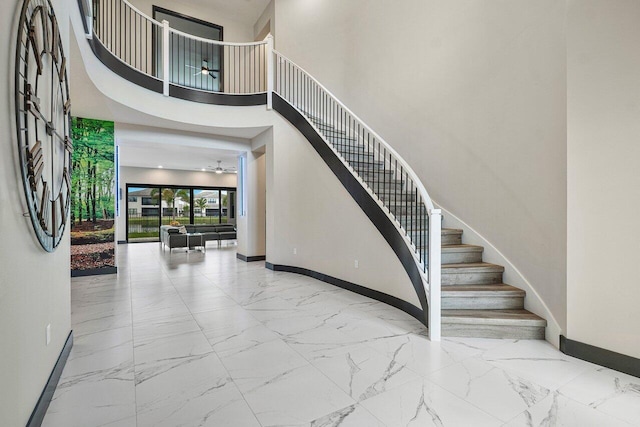 stairway featuring a high ceiling