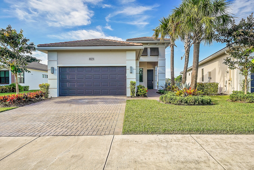 view of front of house with a front lawn and a garage