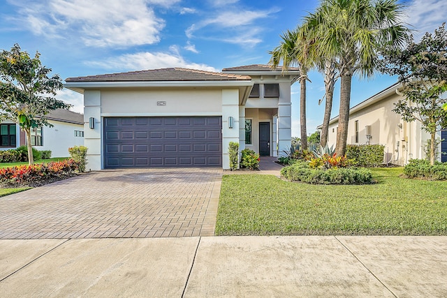 view of front facade with a front yard and a garage