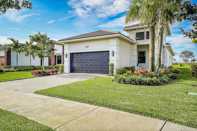 view of front of house featuring a front yard and a garage