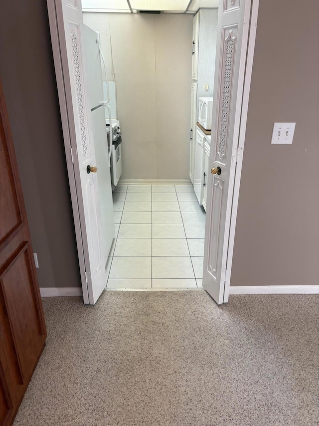 hallway with light colored carpet