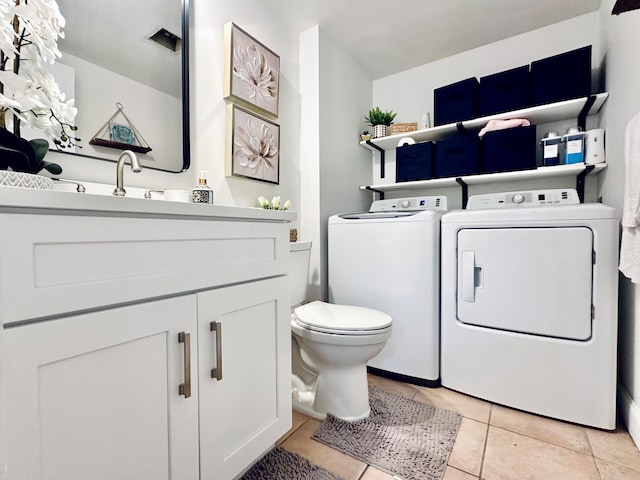 bathroom with separate washer and dryer, vanity, toilet, and tile patterned floors