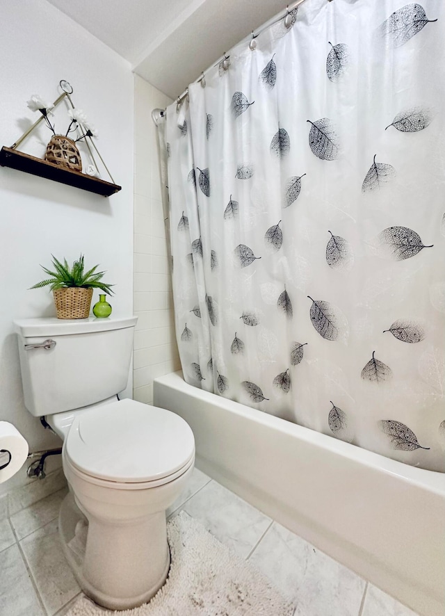 bathroom featuring tile patterned floors, toilet, and shower / bath combo