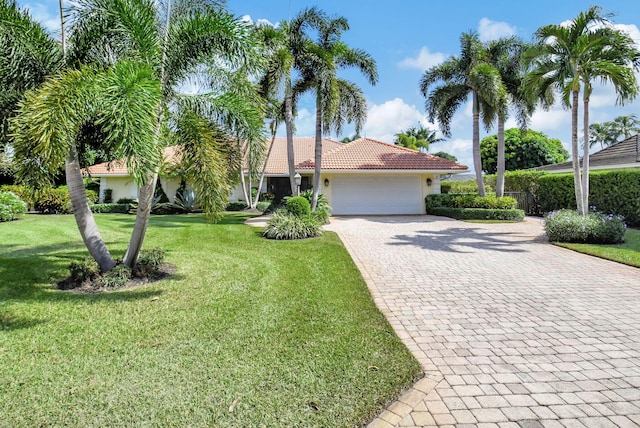 view of front of property featuring a garage and a front lawn