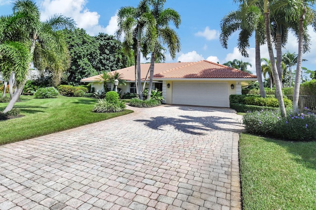 view of front of house with a front yard and a garage