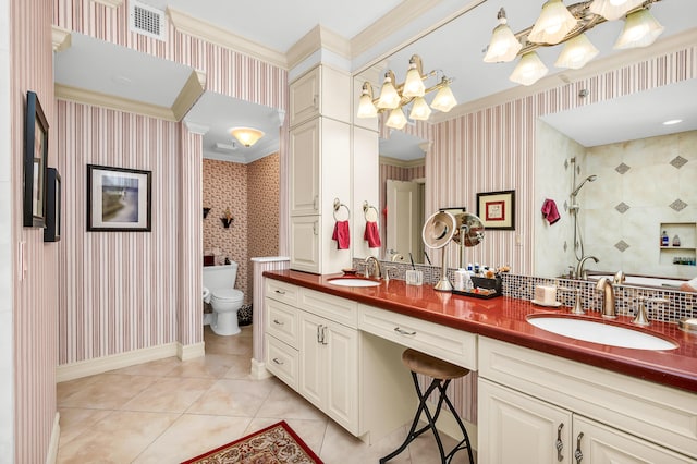 bathroom featuring vanity, a shower, tile patterned floors, crown molding, and toilet