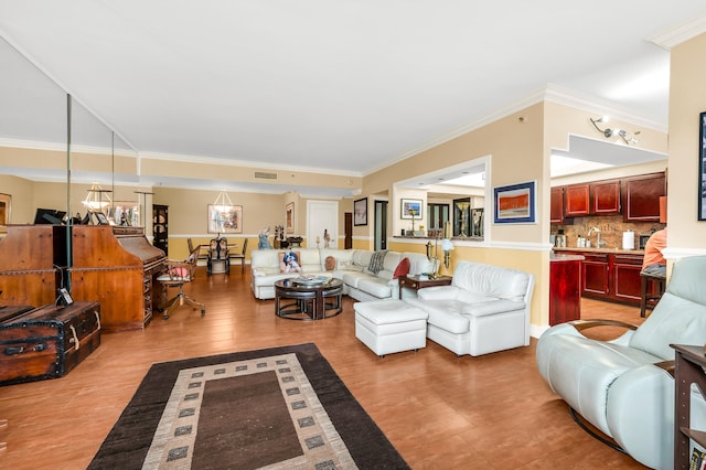 living room with ornamental molding and light wood-type flooring