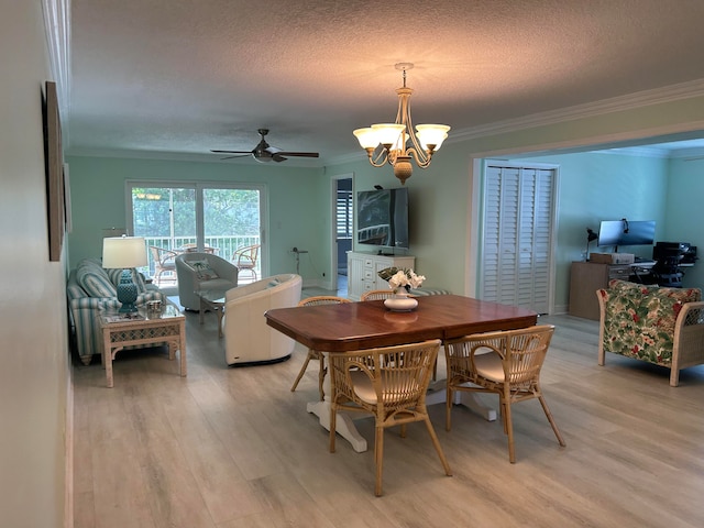 dining area with ceiling fan with notable chandelier, light hardwood / wood-style floors, a textured ceiling, and ornamental molding