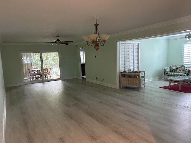 unfurnished living room featuring crown molding, light hardwood / wood-style floors, and ceiling fan with notable chandelier